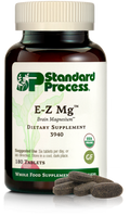 Image of E-Z Mg bottle next to tablets of magnesium supplements.